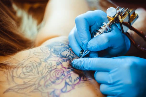 istock master tattoo woman on her back 898728566