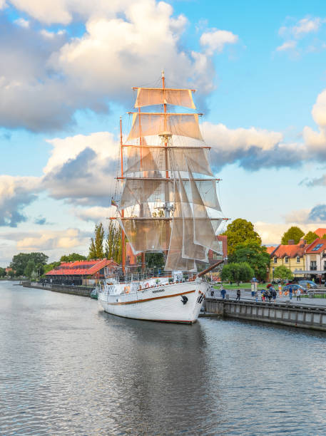 beautiful white yacht - famous symbol of klaipeda. restaurant on sailing boat, dane river and park. - klaipeda imagens e fotografias de stock