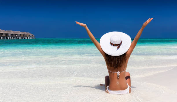 istock Happy woman with white hat on a beach 898732326