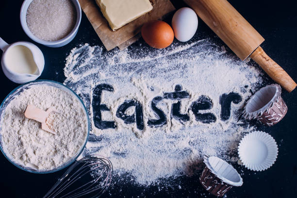 istock Ingredients for baking Easter cake - eggs, flour, milk, butter, sugar) and rolling pin. Baking dark background 898733804