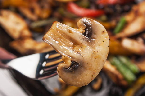 Beef with mushrooms and vegetables fried in a pan