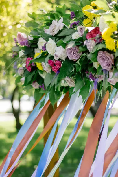 Close up view of flowers on wedding arch.