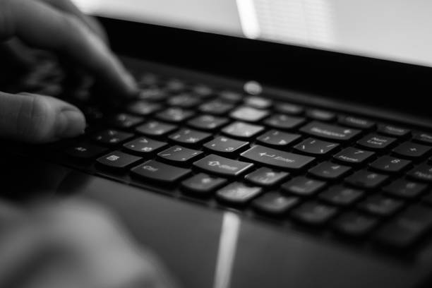 istock Russian hacker hacking the server in the dark Black and white 898751756