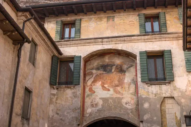 Photo of An ancient fresco of a Venetian lion on the wall of a house in Canegliano. The winged lion of St. Mark is a symbol of the city of Venice and one of the elements of the flag of the Italian fleet.