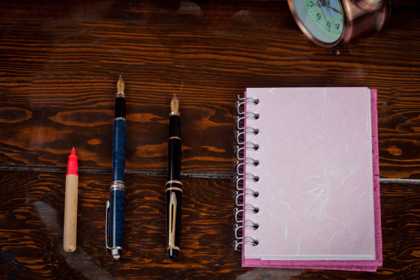 istock Colorful Book note and fountain pen on wood table. 898753576