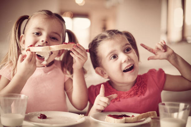 istock Girls eating breakfast. Have fun. 898754428