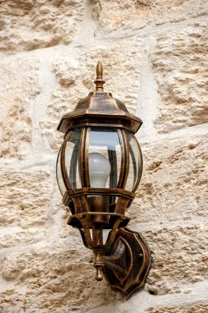 Street lamp on the wall of large blocks of Jerusalem stone