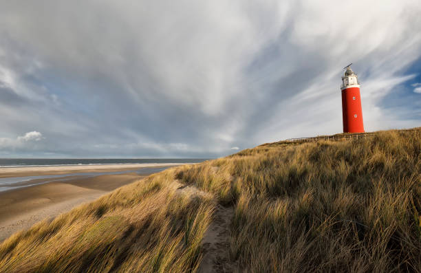 istock red lighthouse on North sea coast, Holland 898761474