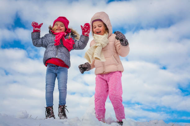 istock Two cute grill in the snow. On the move. 898762308