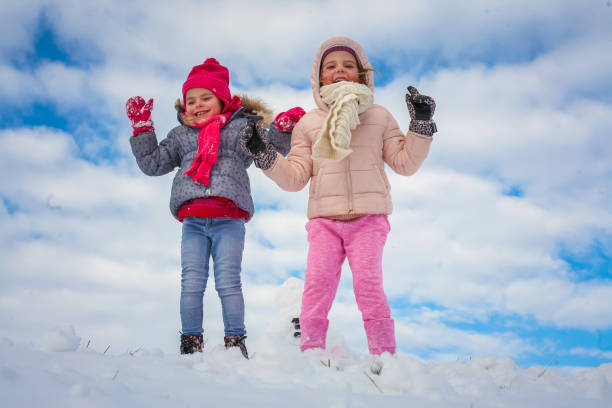 istock Little sisters playing outside. Winter season. 898762426