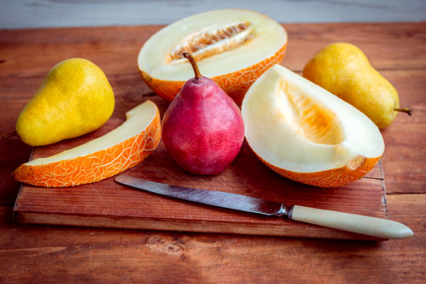istock Fresh ripe juicy melon slices and pears on the table 898764812