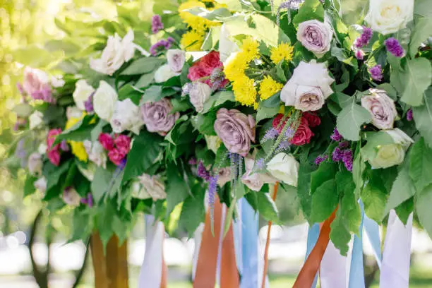 Close up view of flowers on wedding arch.