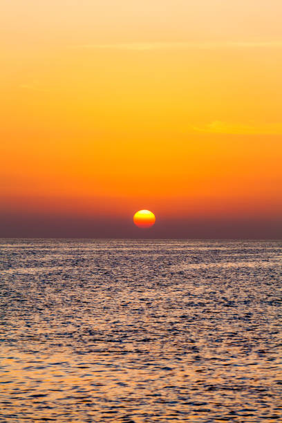 istock sunset over ocean. Sunset on the beach with beautiful sky. Dramatic sunset 898776542
