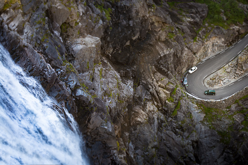 Trollstigen mountain road. Bridge over river with waterfall. Cars on serpentine. Auto travel in Norway, Europe, Scandinavia