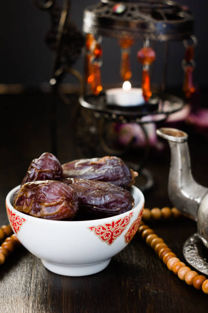 istock Ramadan fasting - dates for iftar in bowl on wooden table. 898780888
