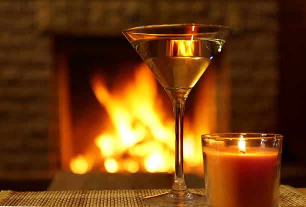 istock Martini glass and christmas candle under fireplace background. 898784056