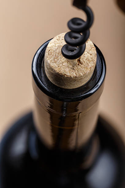 istock a bottle of wine is opened with a corkscrew 898784572