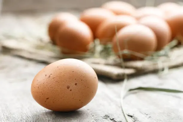 Photo of fresh organic farm eggs lie on burlap