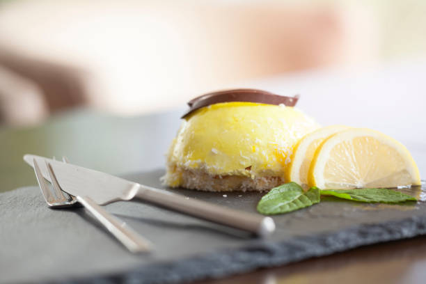 istock Lemon pie on slate with citrus fruits. 898784934