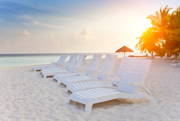 istock Empty beach chairs on sand by the sea 898786344