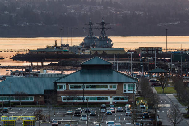 Sunset on the Everett Naval Station December 2017. Sunset on the Everett Naval Station. The naval station, located on the city's waterfront on the northeastern end of Puget Sound, was designed as a homeport for a US Navy carrier strike group and opened in 1994. At sunset you can hear them playing taps in houses on the surrounding hill. everett washington state photos stock pictures, royalty-free photos & images
