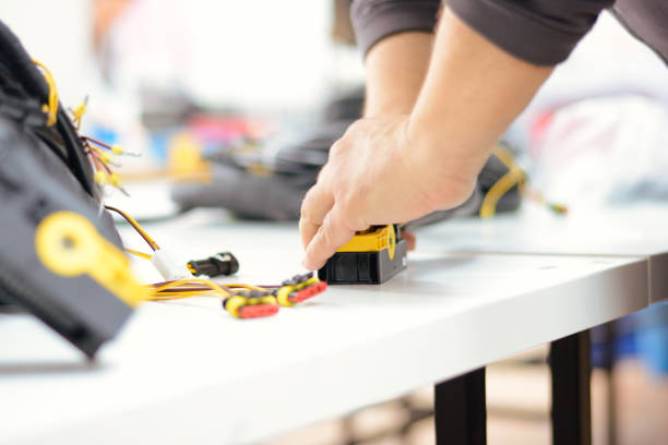 istock Man working with wires, connectors used in auto-electrical industry. 898788960