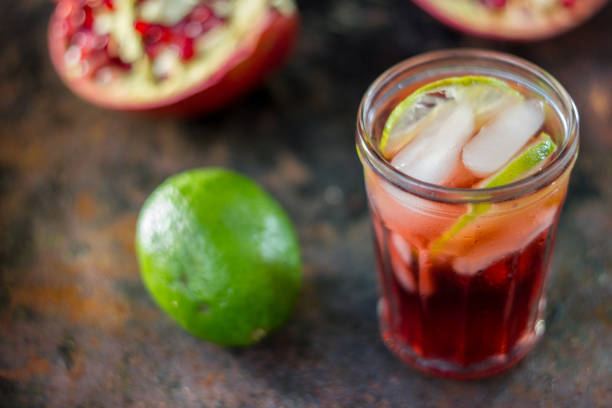 istock Fresh pomegranate drink - lemonade or cocktail with lime and ice 898793330
