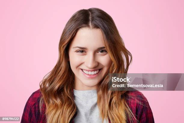 Cheerful Pleasant Looking Female Model Has Shining Smile With Perfect White Even Teeth Glad To Recieve Compliment From Boyfriend Isolated Over Pink Background Happiness And Beauty Concept Stock Photo - Download Image Now