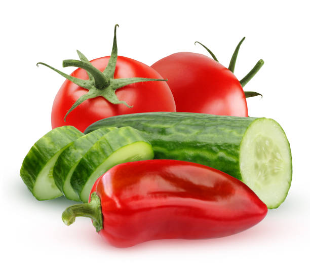 istock Vegetables for salad. Ingredients. Cucumber, pepper and tomatoes isolated on white 898795058
