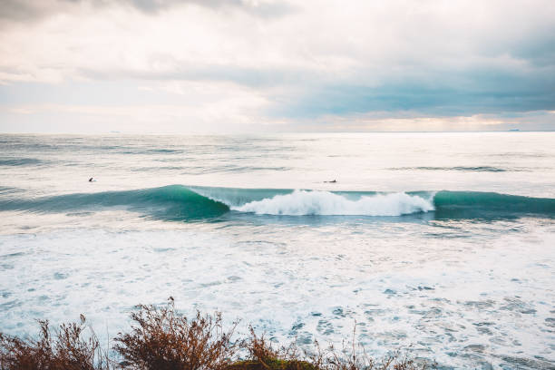 istock Perfect breaking ocean barrel wave and surfers 898798784