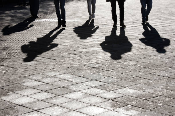istock Leegs and shadow of five people 898801676