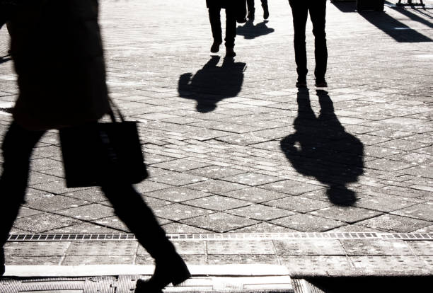 istock People silhouettes and shadows on city streets 898801780