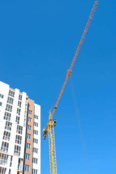 istock Construction tower crane and new building over blue sky background. 898802858
