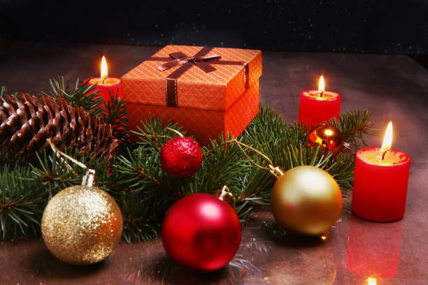 istock christmas decoration with gift boxes, red candles, christmas tree and colorful balls. Selective focus. 898809014