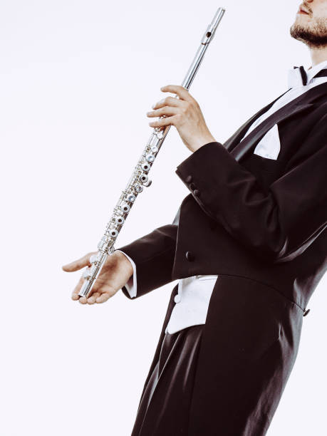 istock Male flutist wearing tailcoat holds flute 898812746