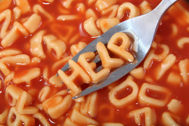 istock Spaghetti letter spelling the word help with the letters held up on a fork. 898813542