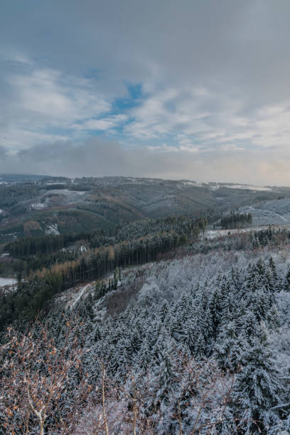 istock View from Semnicka rock with cloudy sun and snow in west Bohemia 898817628