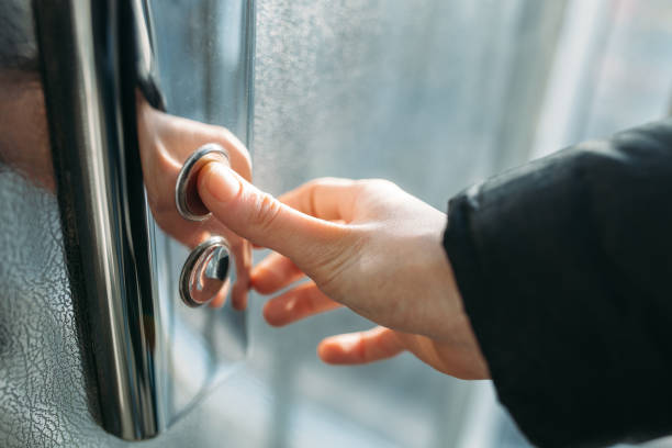 istock The thumb presses the Elevator button, a hand reaching for the button, the girl waiting for Elevator, push button start 898818096
