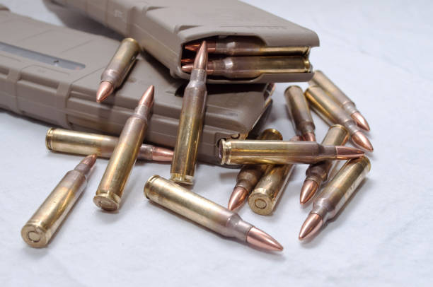 istock Two .223 rifle magazines with bullets laying next to them 898828886