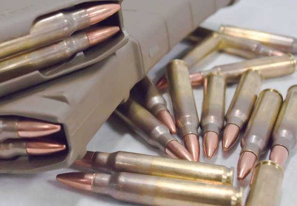istock Two .223 rifle magazines with bullets laying next to them 898828906