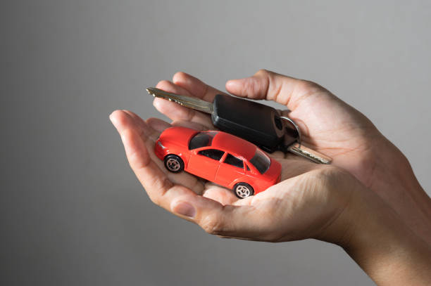 istock Car toy and key in hand. 898830248