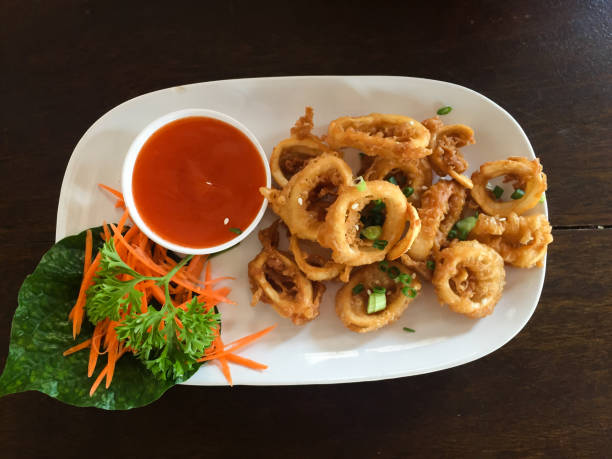 istock Fried squid rings with hot spicy sauce 898831520