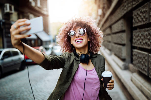 Taking a selfie Girl taking a selfie and enjoying her day off photo messaging stock pictures, royalty-free photos & images