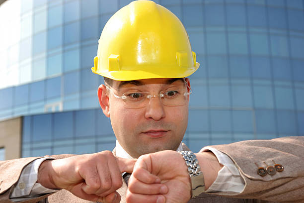 businessman looking at his watch stock photo