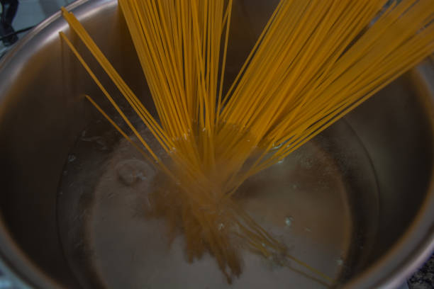 istock Cooking pasta in boiled water 898847170