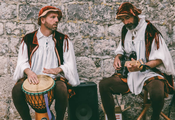 Dubrovnik, Croatia - April 30, 2017 : Two men in traditional clothing playing music instruments in the old city core in Dubrovnik, Croatia.