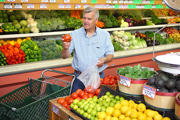 istock Man picking out produce in grocery store 89886424