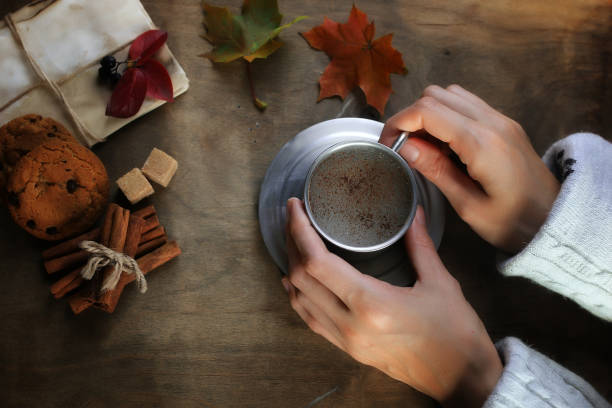 istock hands holding a mug of hot coffee on a table 898865290