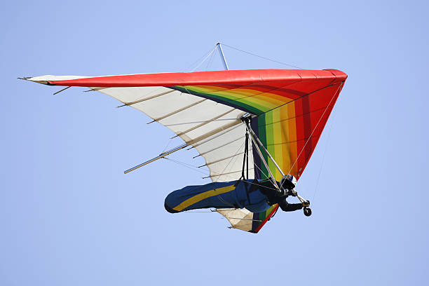 Man hang gliding with blue sky at the background Hang Glider with clear blue sky.SF,Ca hang glider stock pictures, royalty-free photos & images