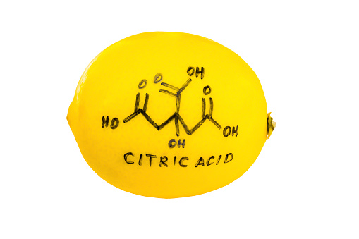 structure of a citric acid molecule painted on lemon peel, abstract background